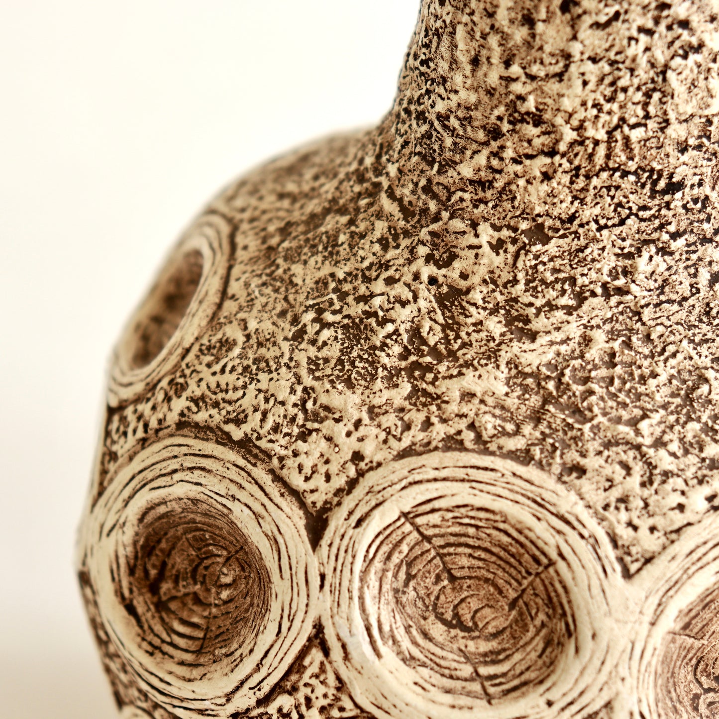 Detail of chalkware lamp showing organic relief decoration
