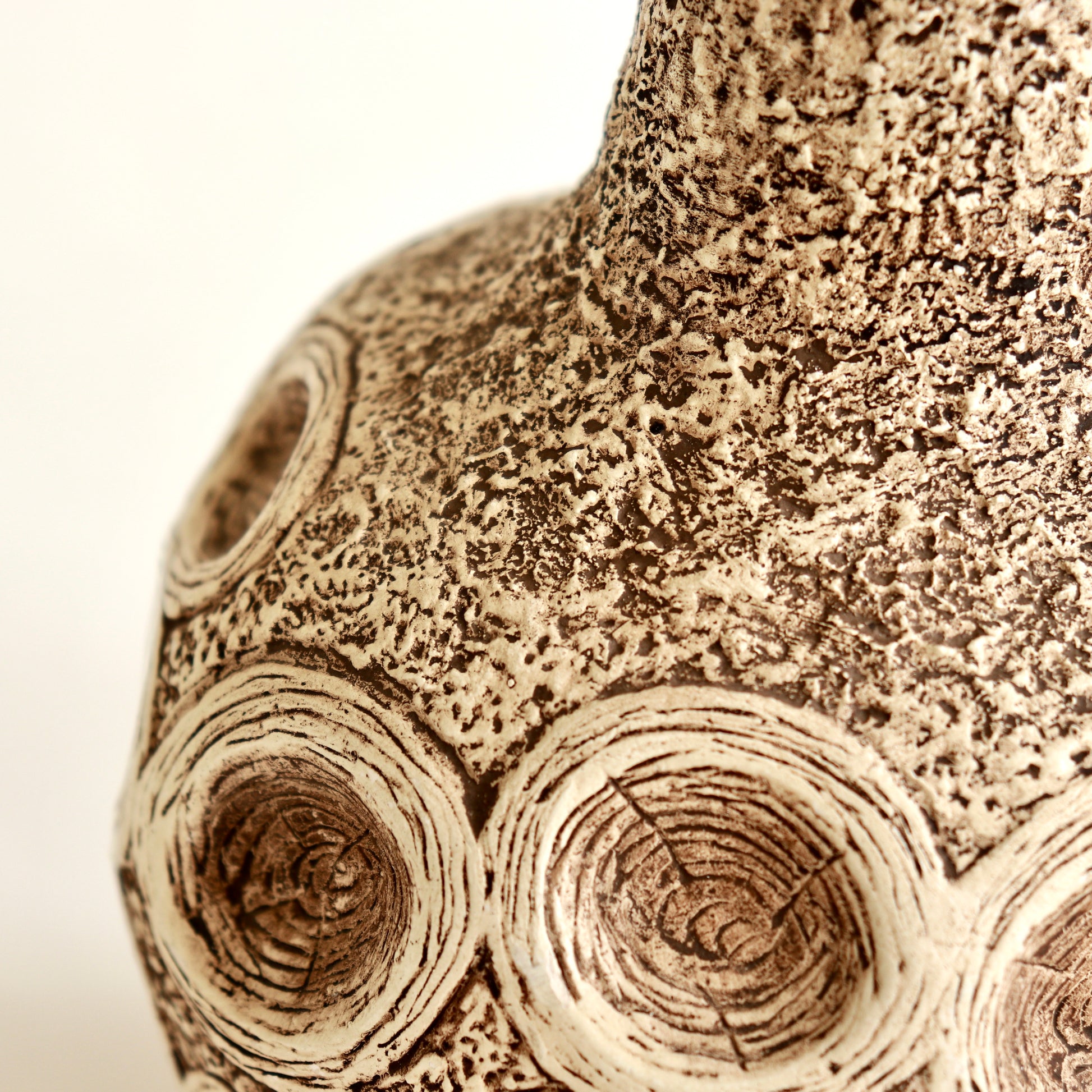 Detail of chalkware lamp showing organic relief decoration
