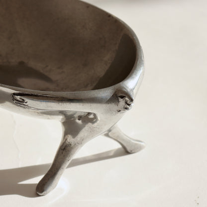 Sculptural aluminium bowl with human figures support