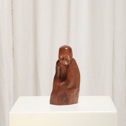 “Mid-century hand-carved wooden figure, faceted surface, three-quarter view”