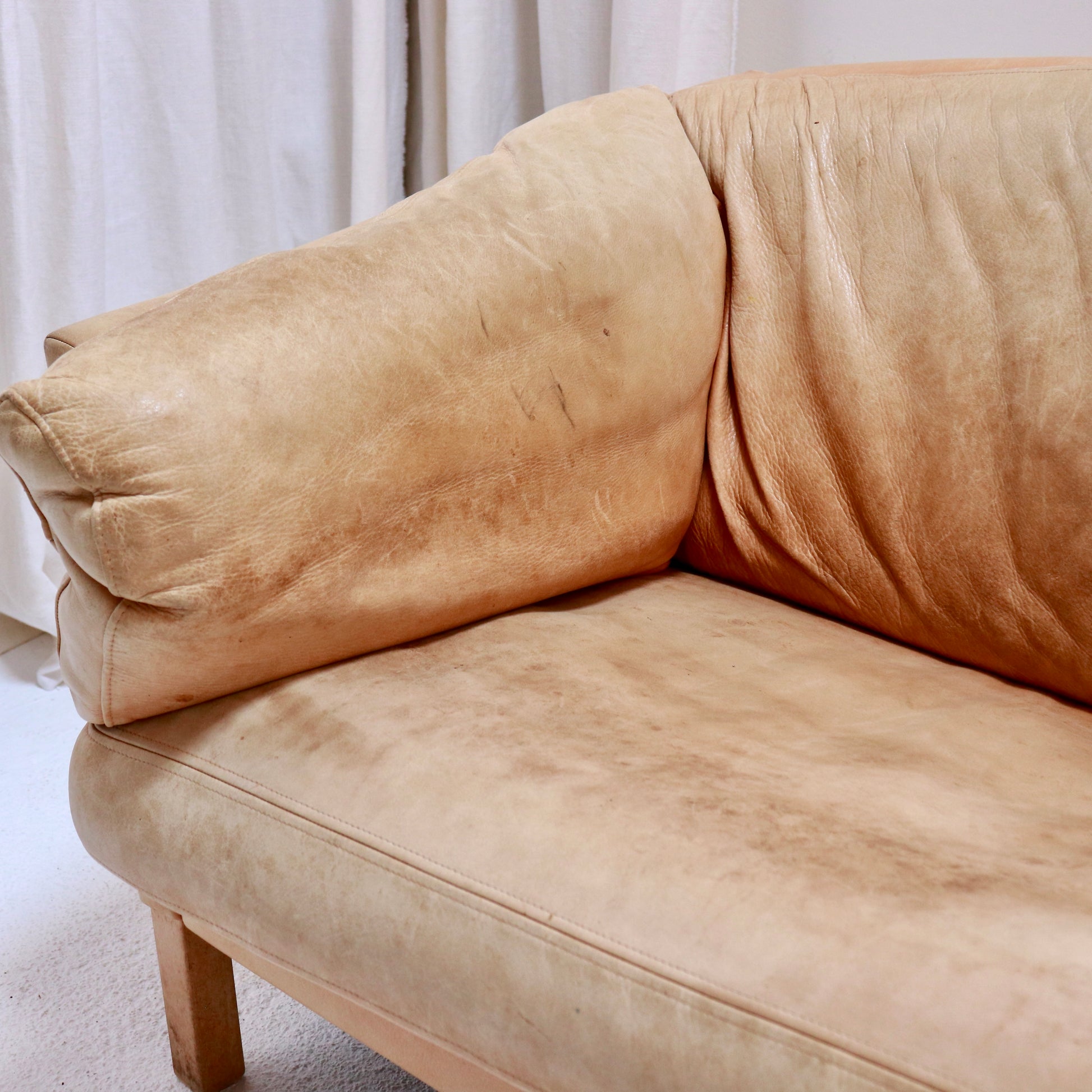 “Seat and arm close-up showing natural wear on Mogens Hansen leather sofa.”
