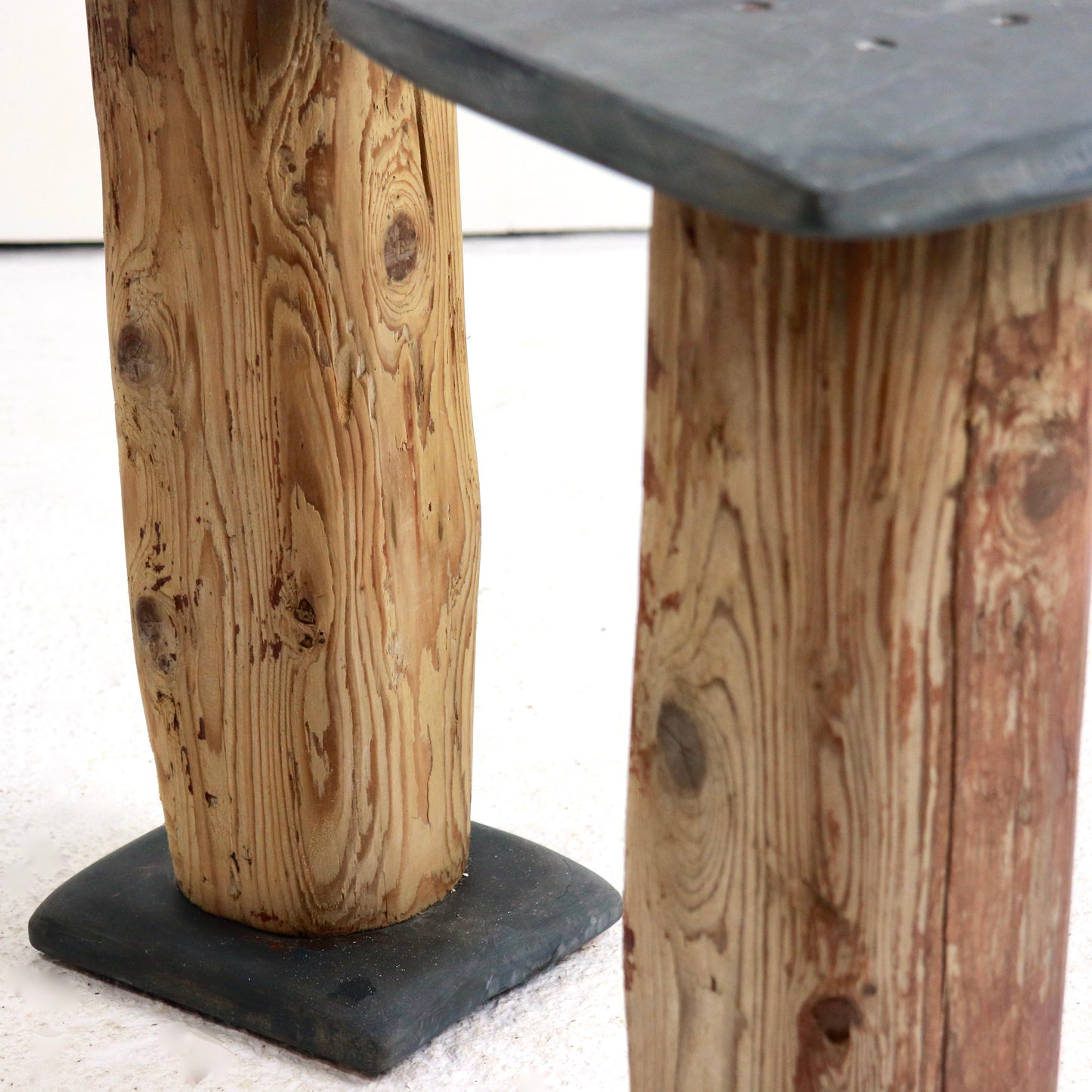 Slate-topped timber side tables with sculptural bases