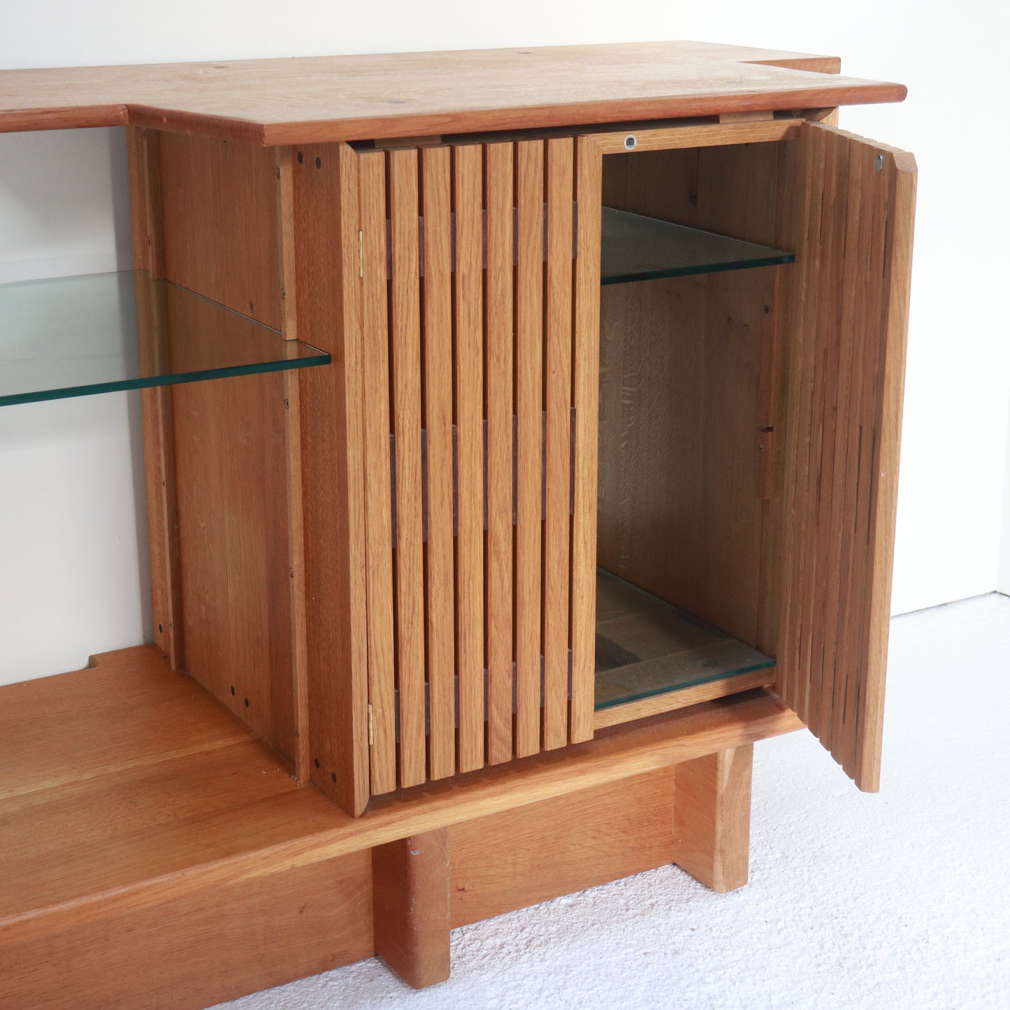 Interior view of oak cabinet with glass shelving
