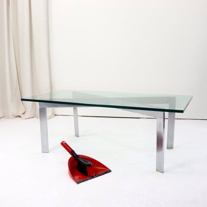 Glass-topped modernist table showing structural X-brace