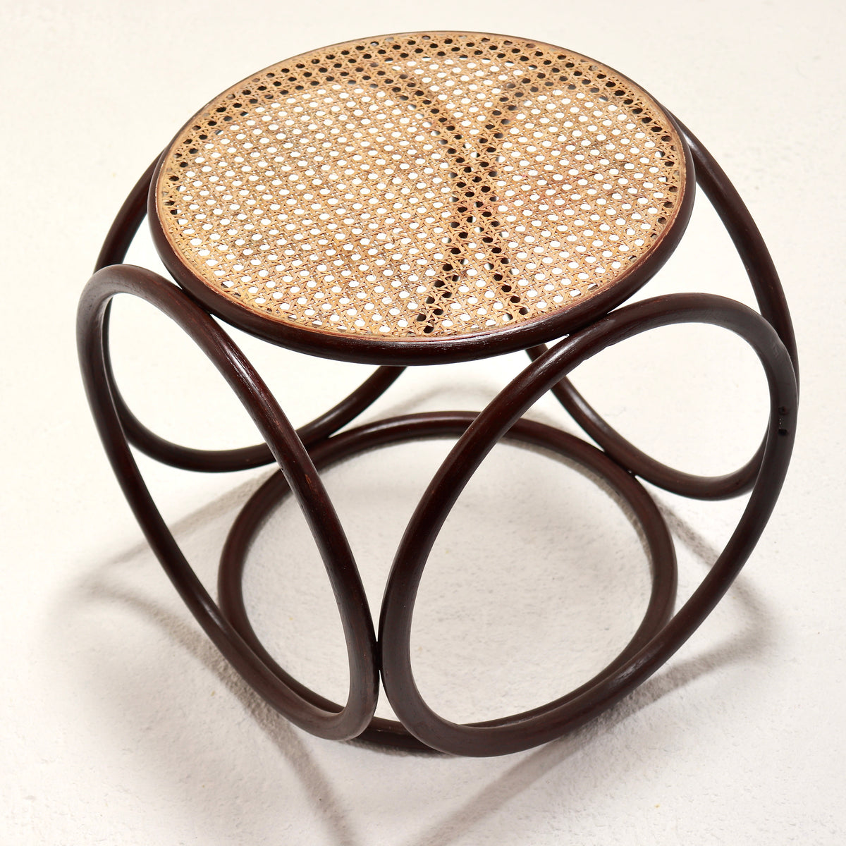 Overhead view of the woven cane seat and curved frame