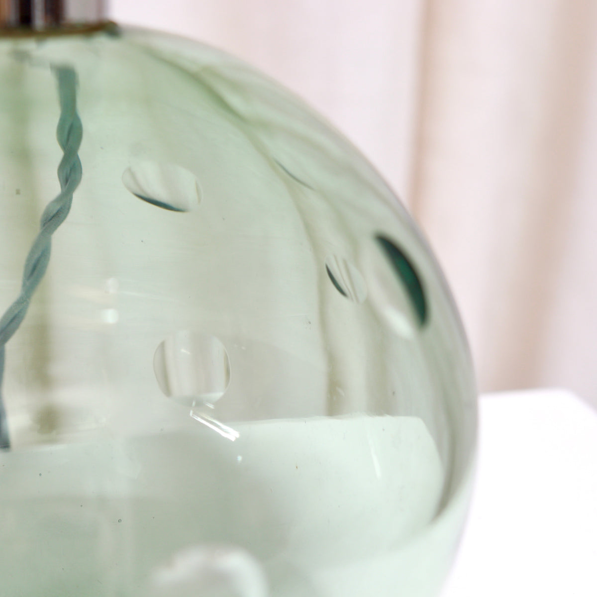 Hand cut lens details on vintage French green glass lamp
