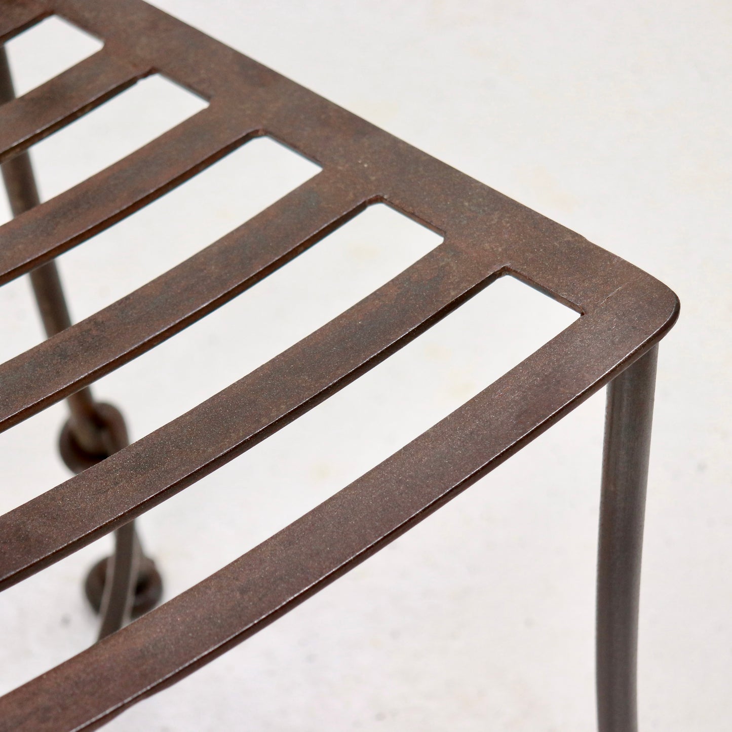 Slatted iron seat with aged patina