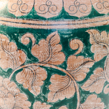 Close-up of hand painted floral decoration on terracotta vase