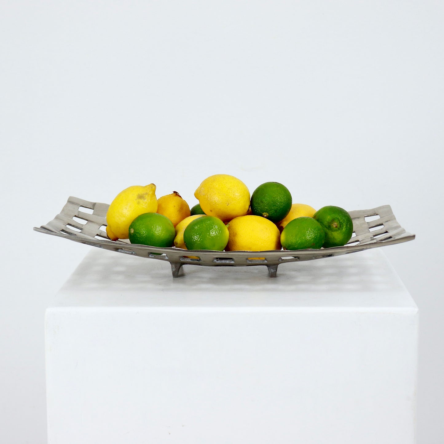 Aluminium openwork fruit basket styled with lemons and limes