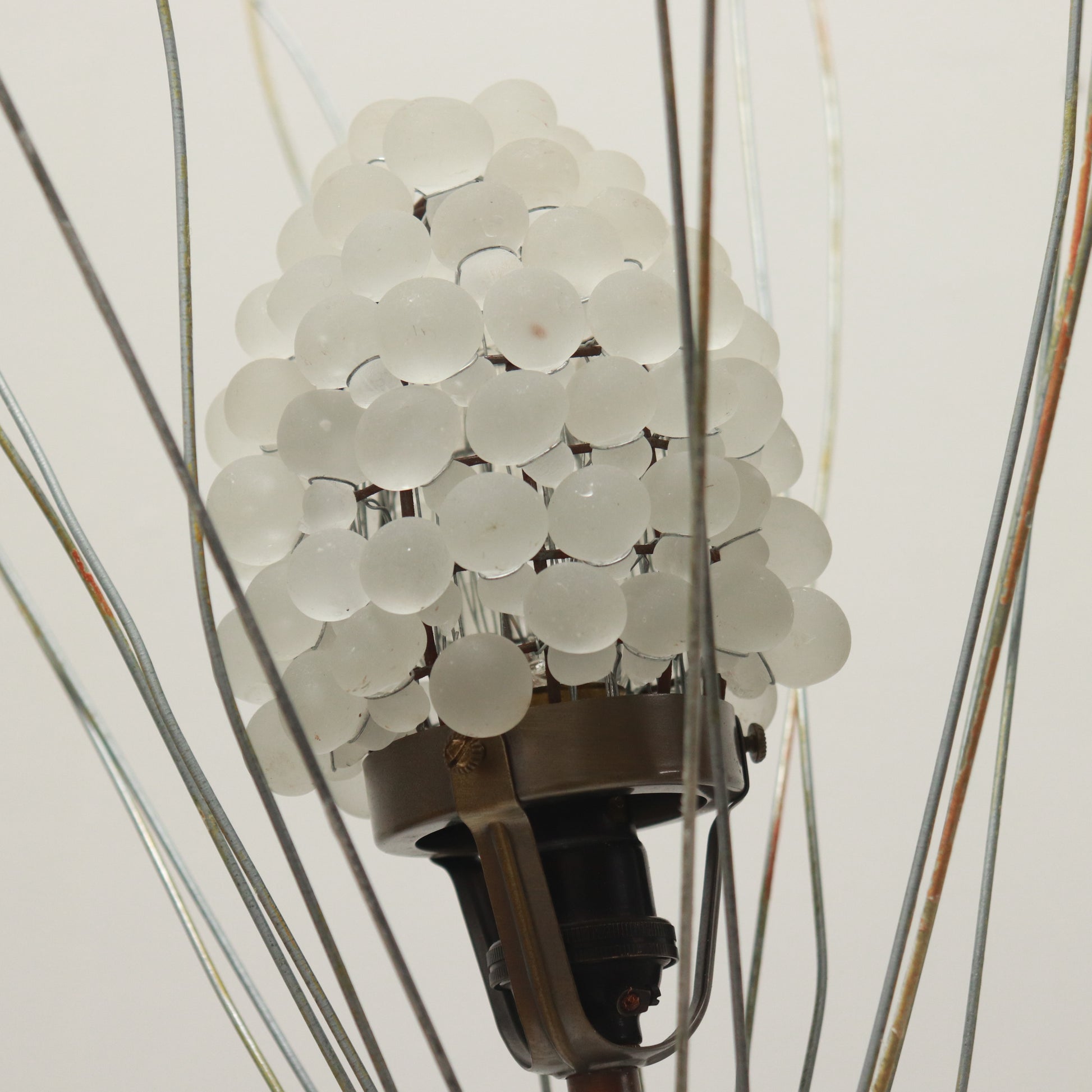 Wirework crown surrounding glass shade on mid-century lamp