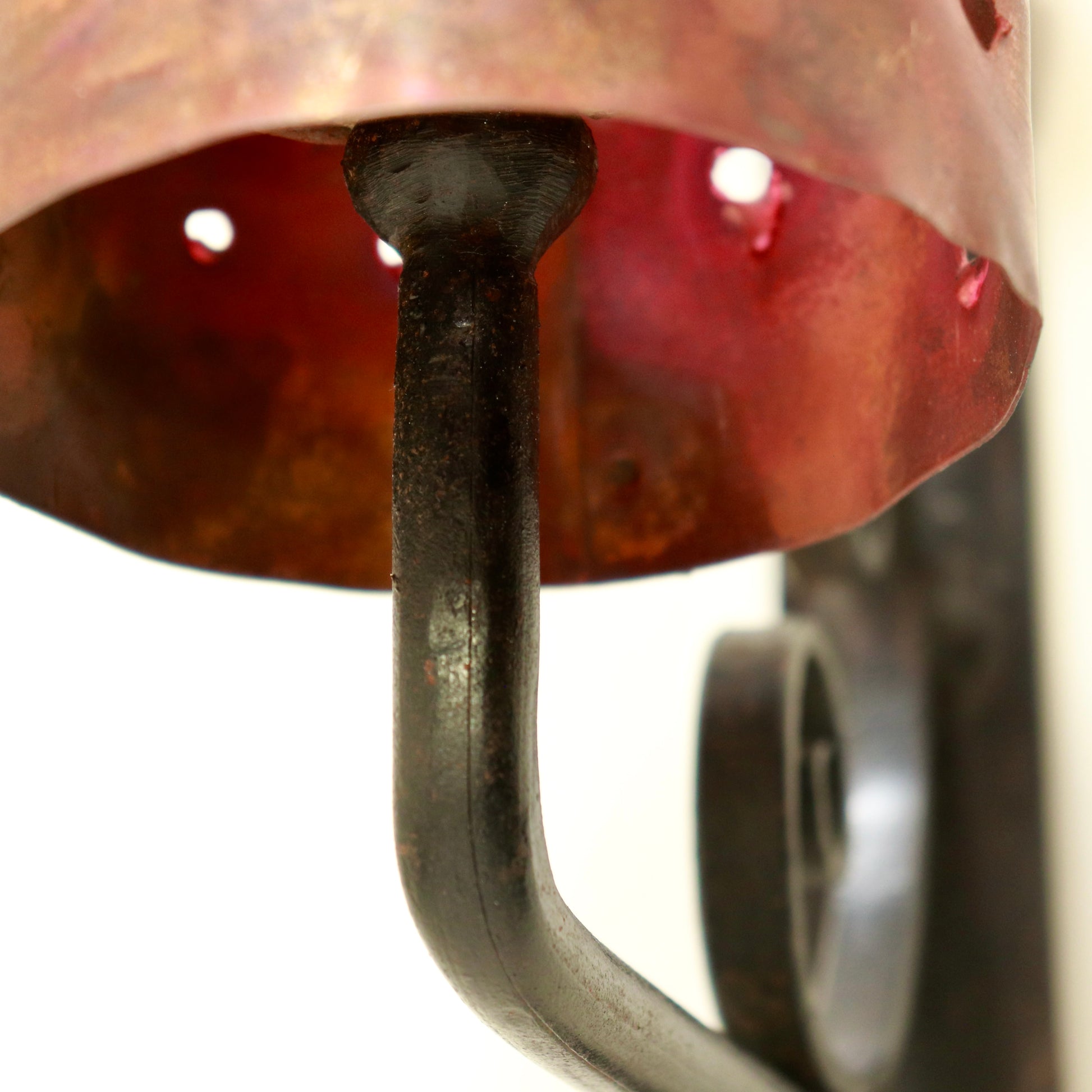 Underside view of iron arm supporting the copper shade