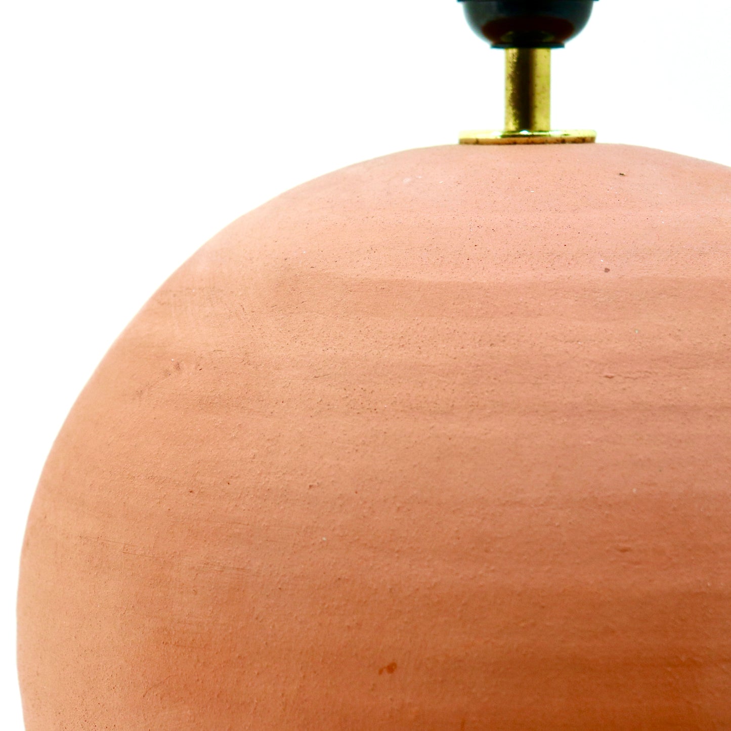 Unglazed clay spherical lamp base, close-up detail