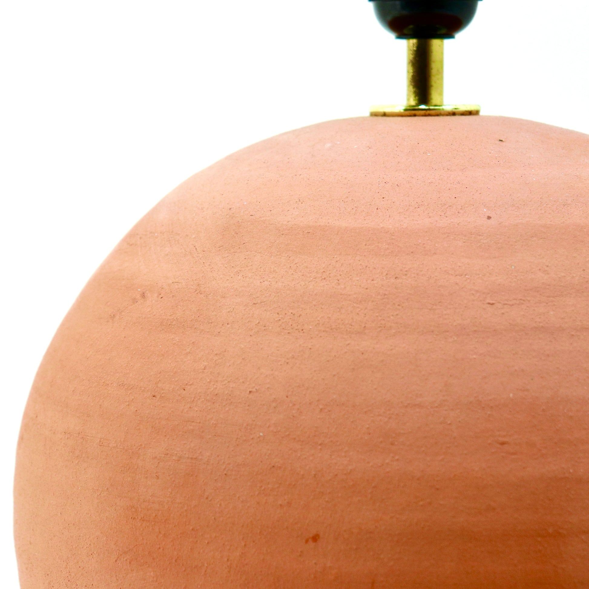 Unglazed clay spherical lamp base, close-up detail