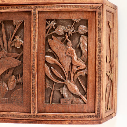 Folk art cupboard with carved figures and foliage