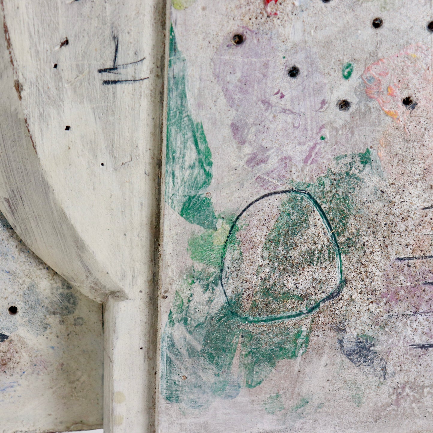 Detail of drilled holes, pigments and incised lines on sculpture