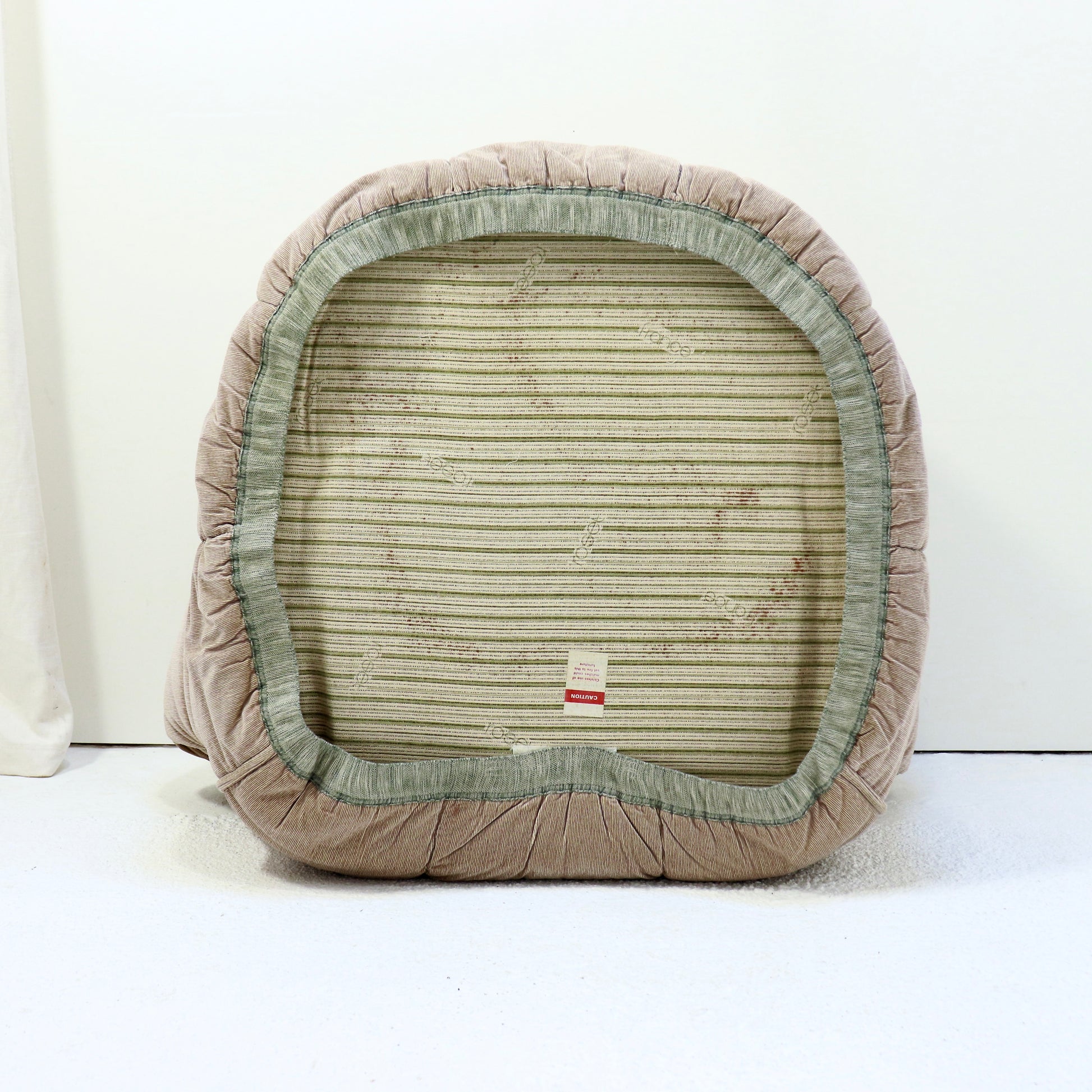 “Underside of chair with original Roset base cloth and label.”