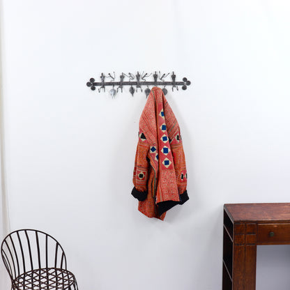 Vintage iron wall coat rack in hallway