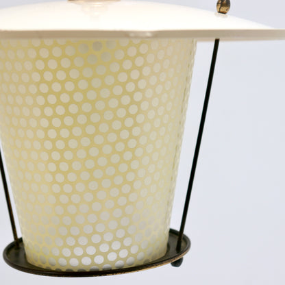 Close-up of the pendant’s dotted glass, slender supporting rods and patinated lower metal ring.