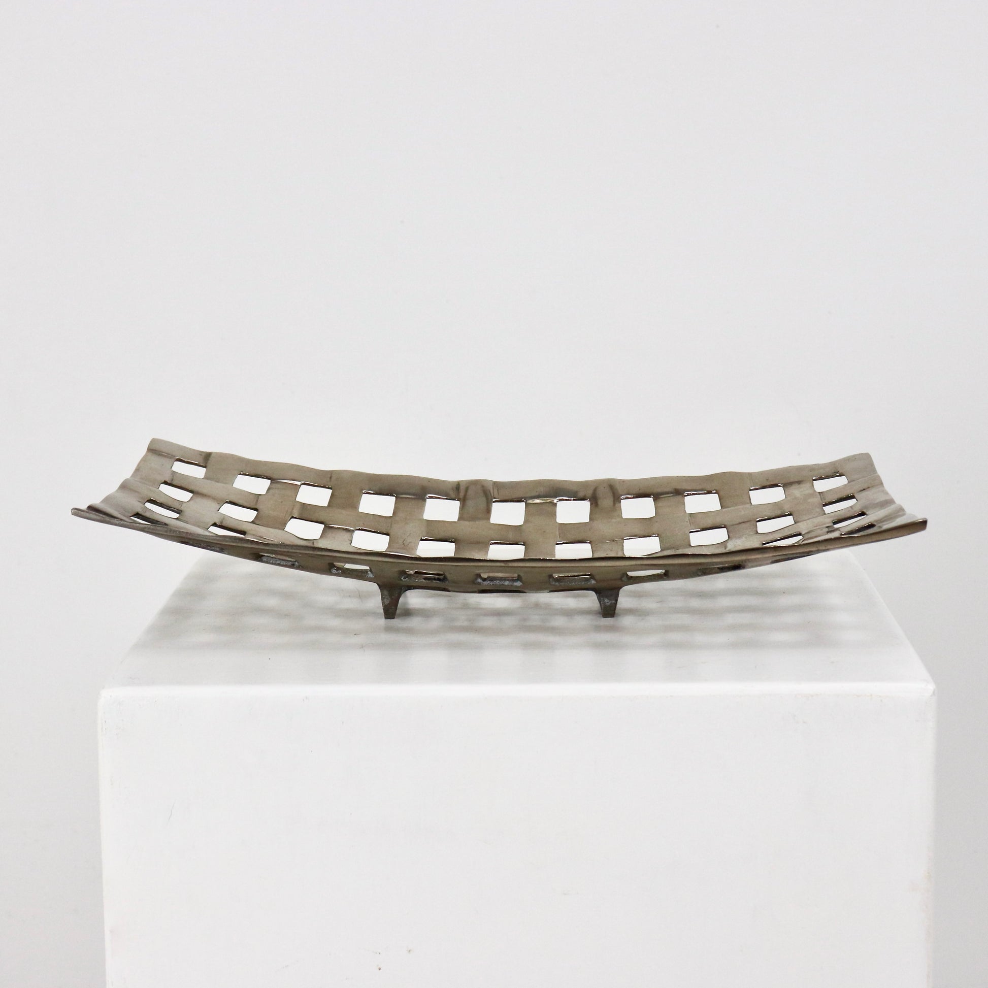 Sculptural aluminium lattice bowl shown as tabletop centrepiece