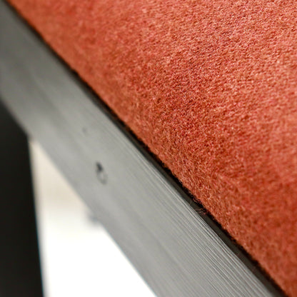 “Detail of rust-coloured Kvadrat wool-felt upholstered seat”