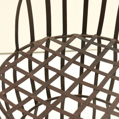 Close-up of riveted lattice seat with time-softened patina.