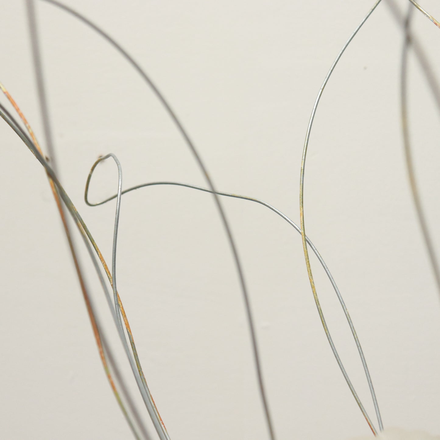 Wire tendrils framing handmade glass shade