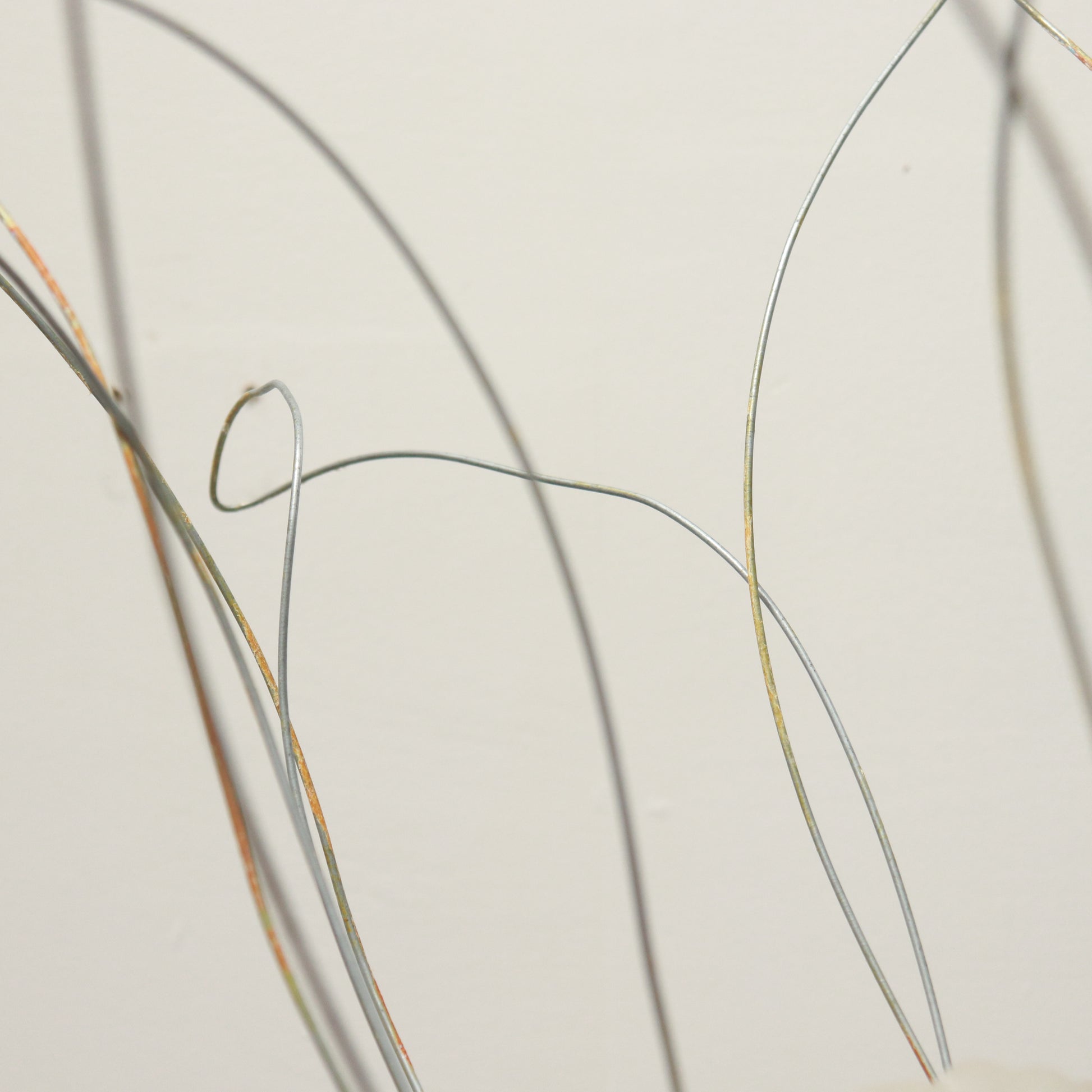 Wire tendrils framing handmade glass shade