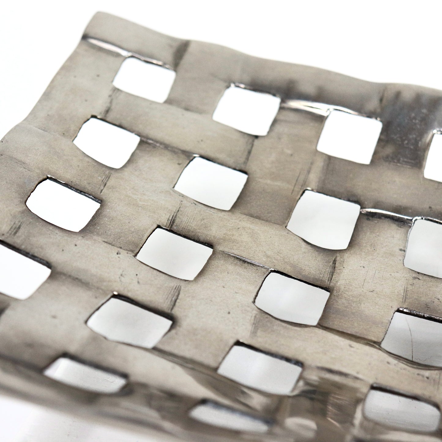 Detail of woven lattice texture on aluminium centrepiece bowl