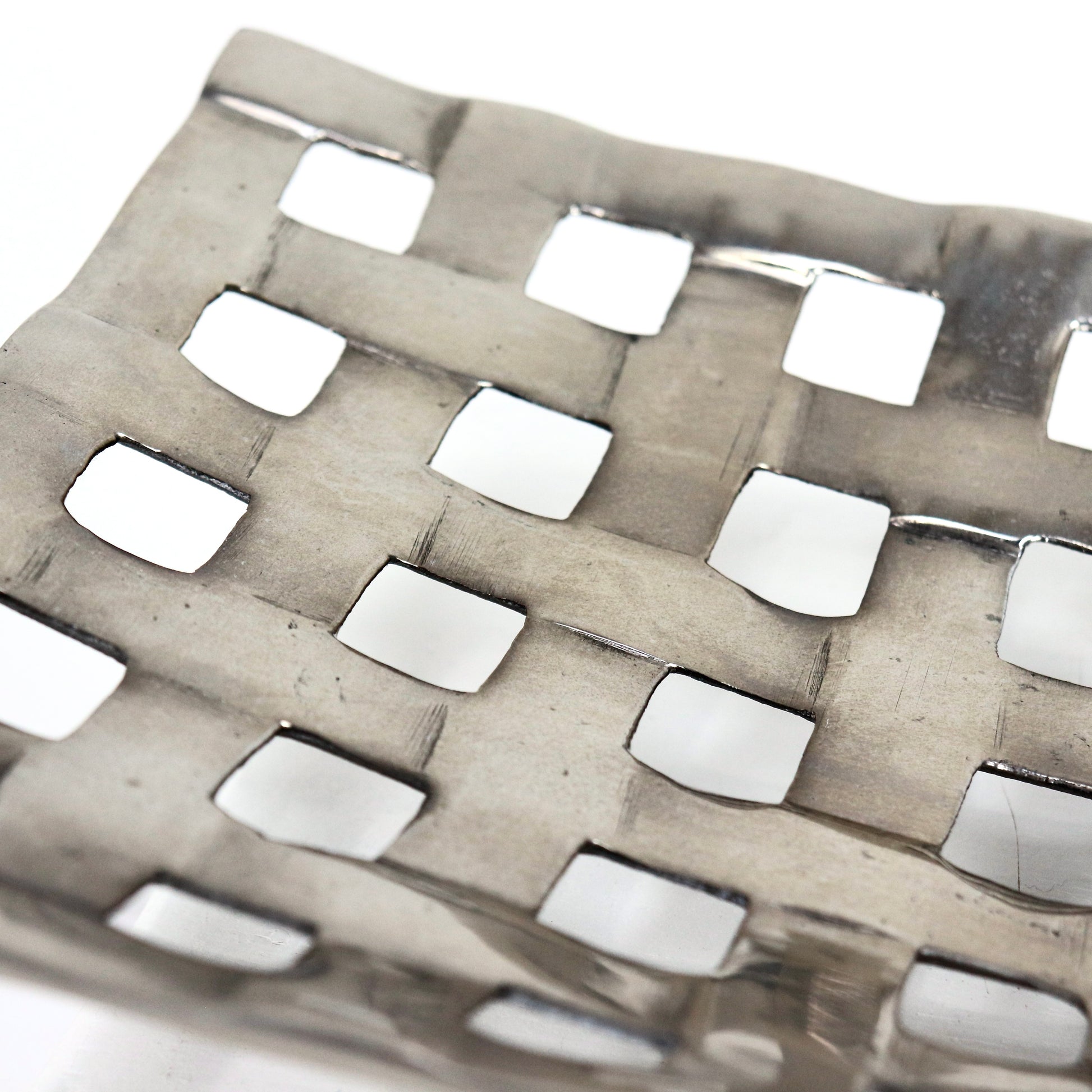 Detail of woven lattice texture on aluminium centrepiece bowl