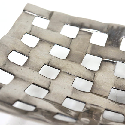 Detail of woven lattice texture on aluminium centrepiece bowl