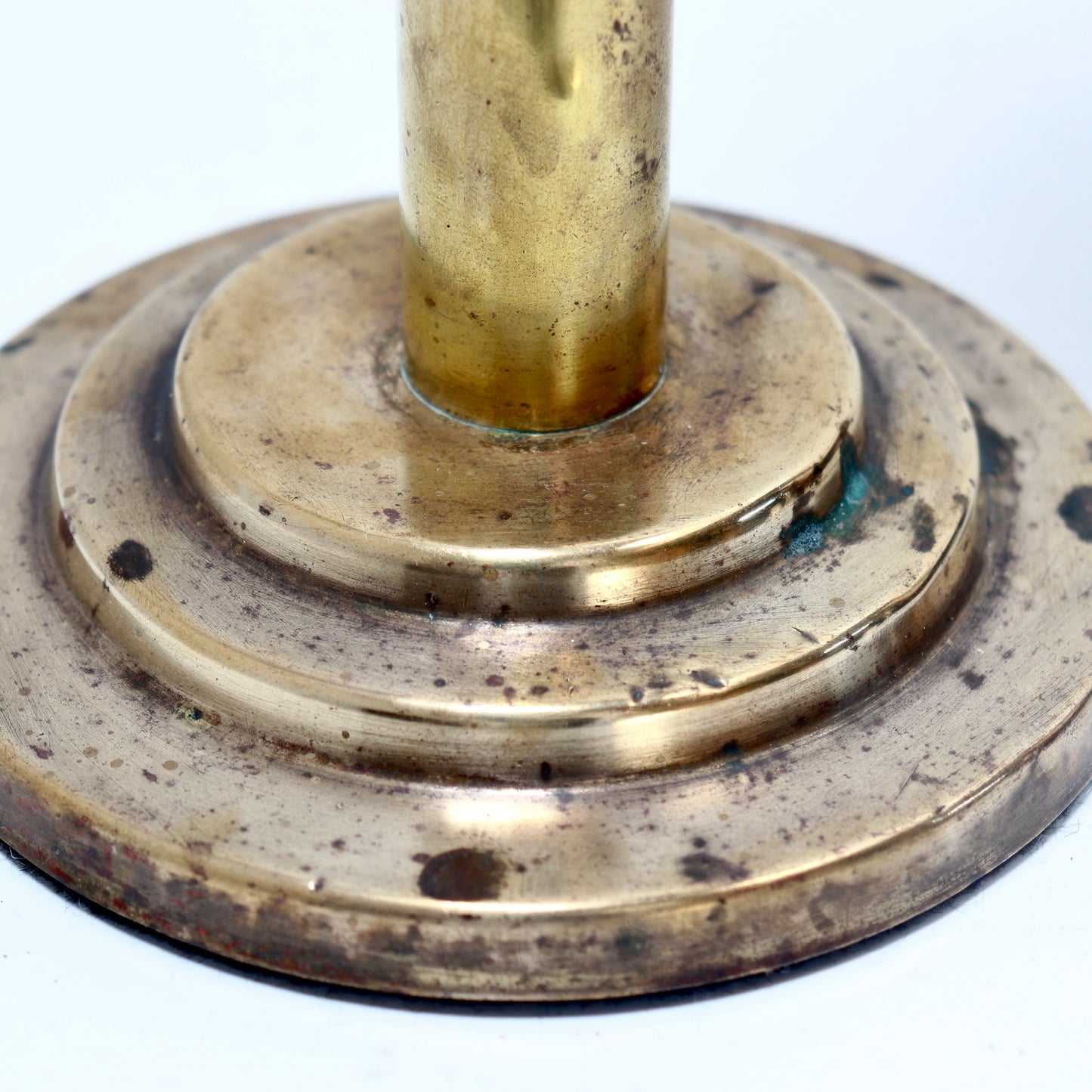 Brass vase showing aged patina and stepped base