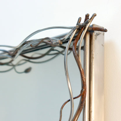 Close-up of hand-worked copper and steel mirror frame