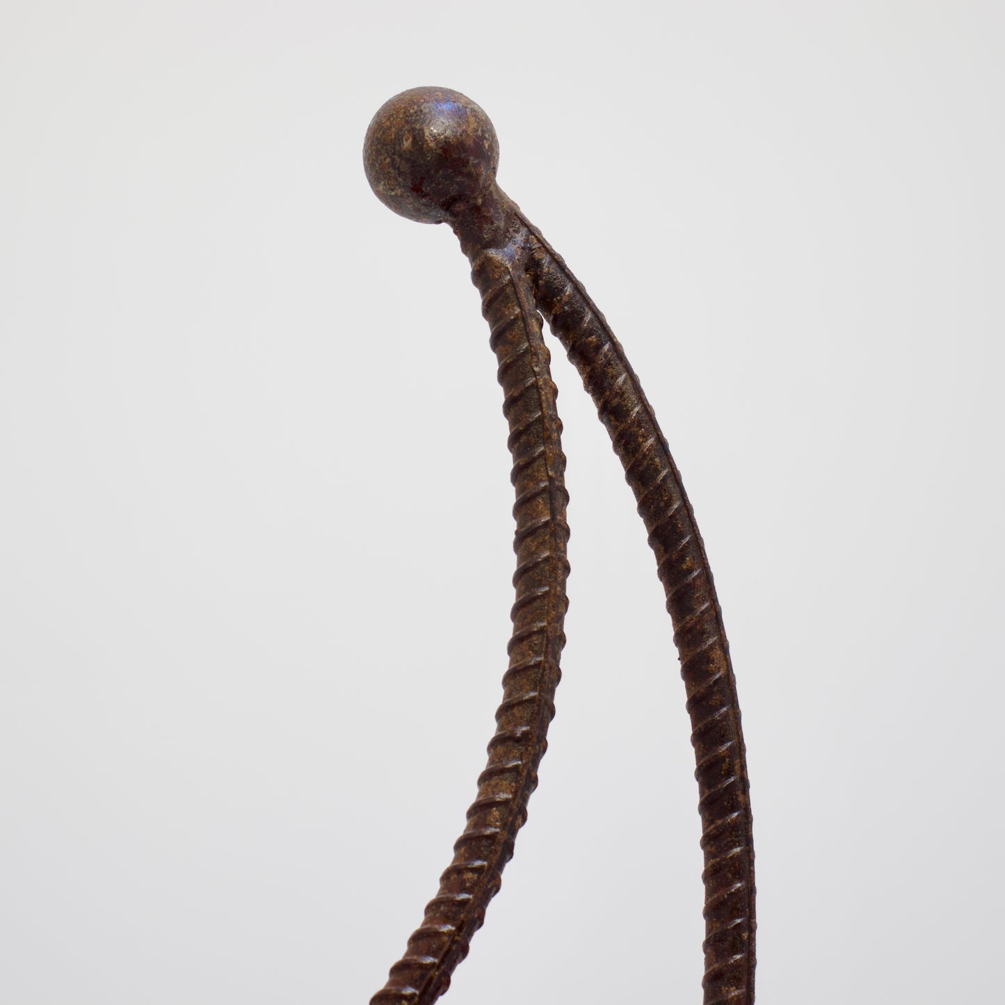 Close-up of crescent back detail in twisted rebar iron chair