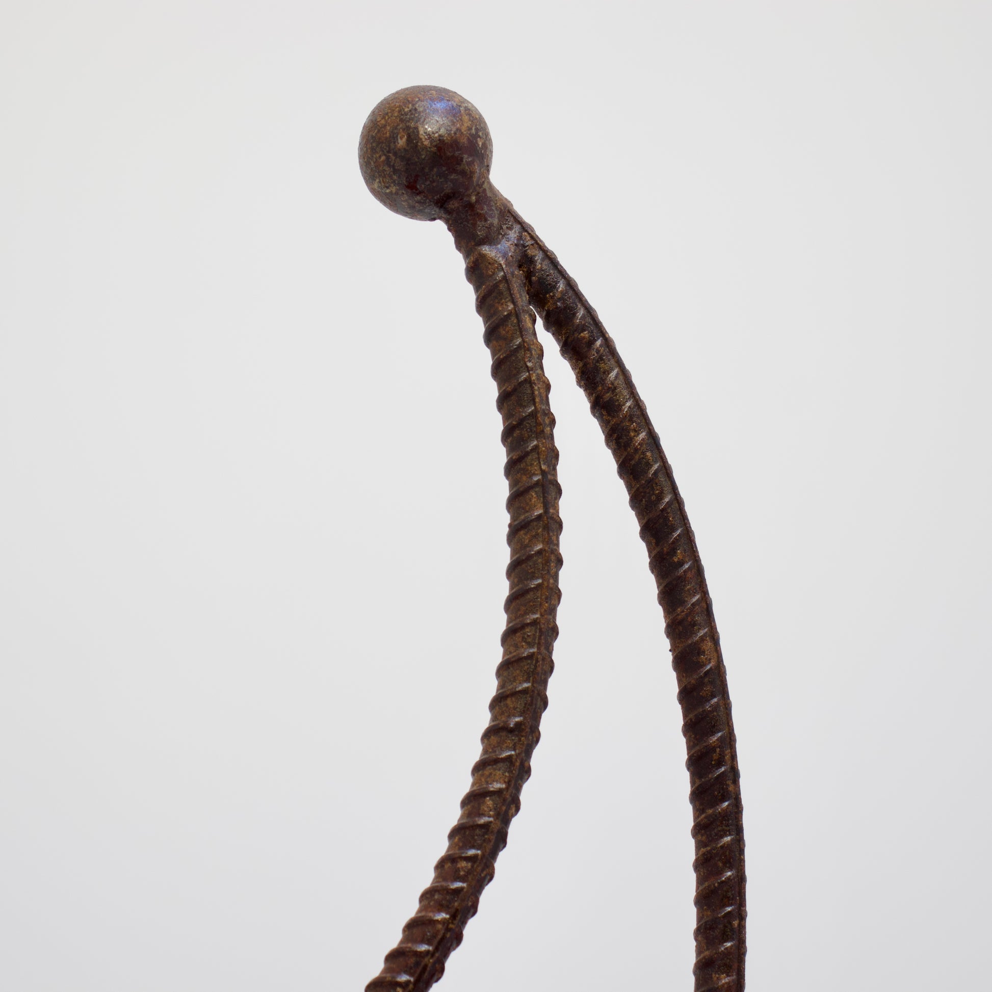 Close-up of crescent back detail in twisted rebar iron chair