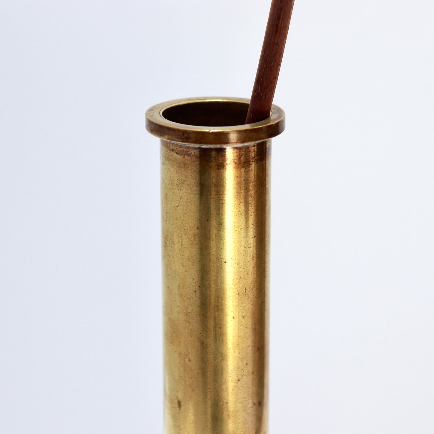Patinated brass single flower vase detail