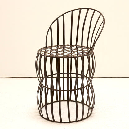 Early 20th-century French iron strap chair with riveted lattice seat, front view.