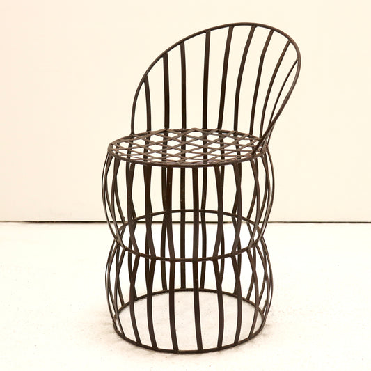 Early 20th-century French iron strap chair with riveted lattice seat, front view.