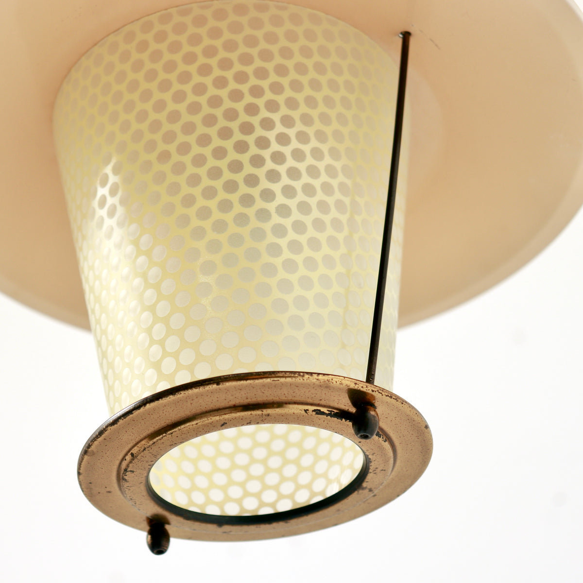 Underside detail showing the open glass diffuser, circular metal rim and wear to the fittings.