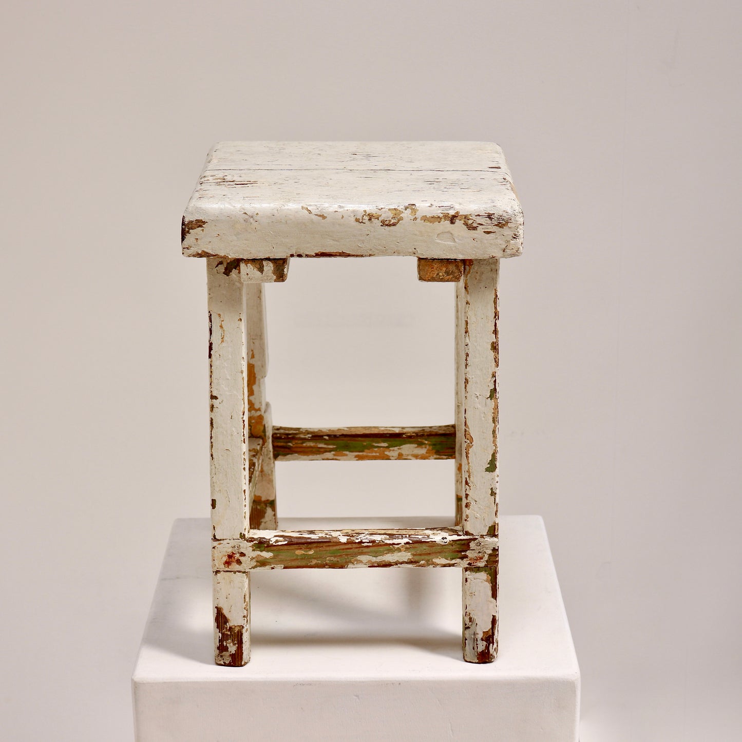 Rustic folk art stool with square top and stretcher base