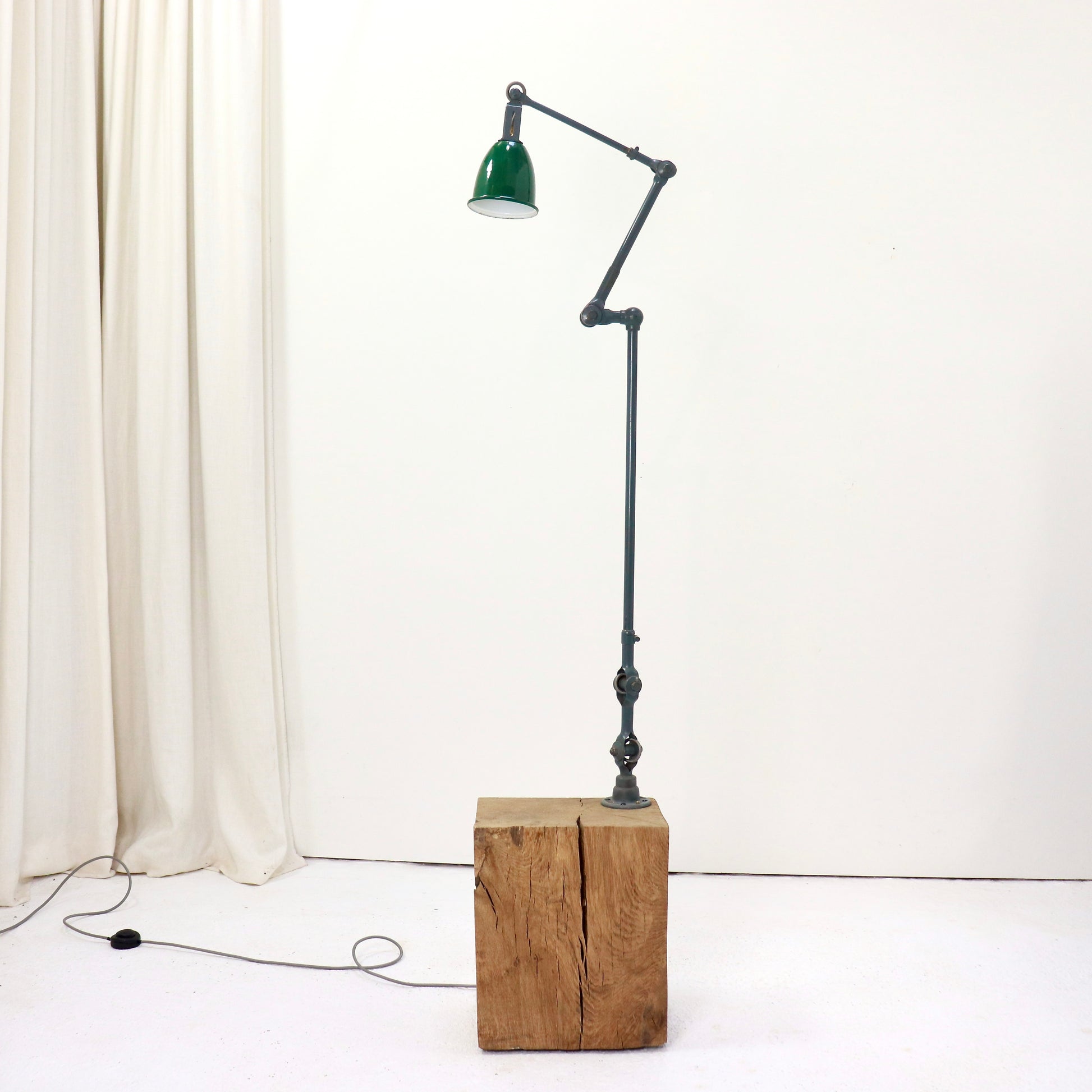 Articulated industrial floor lamp with green enamel shade