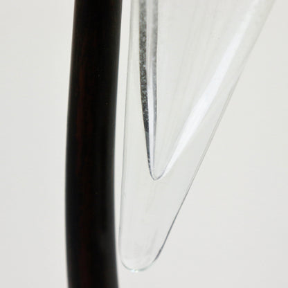 Tip of glass cone against slender iron stem, detail.