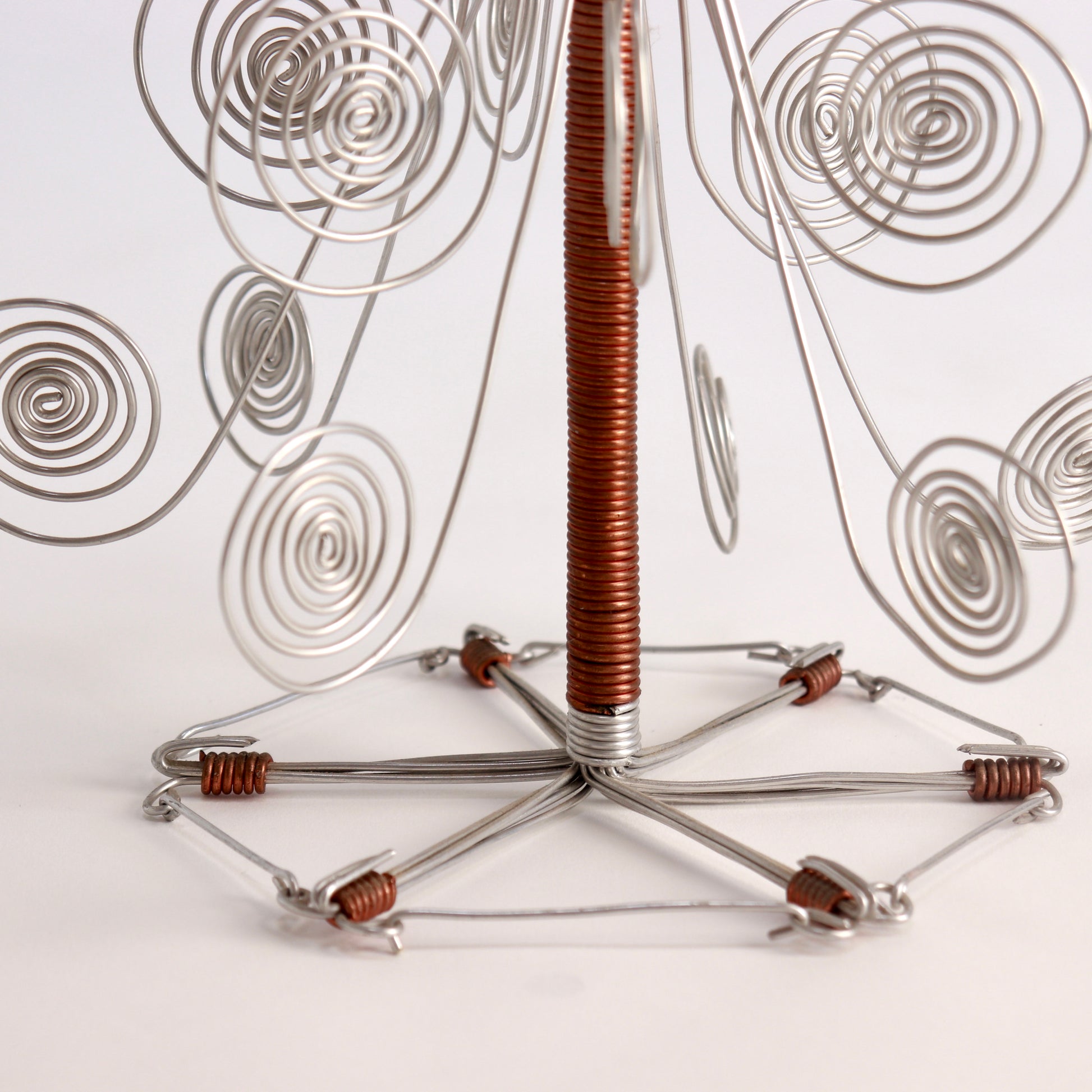 Copper coil bindings on handmade wire candle holder