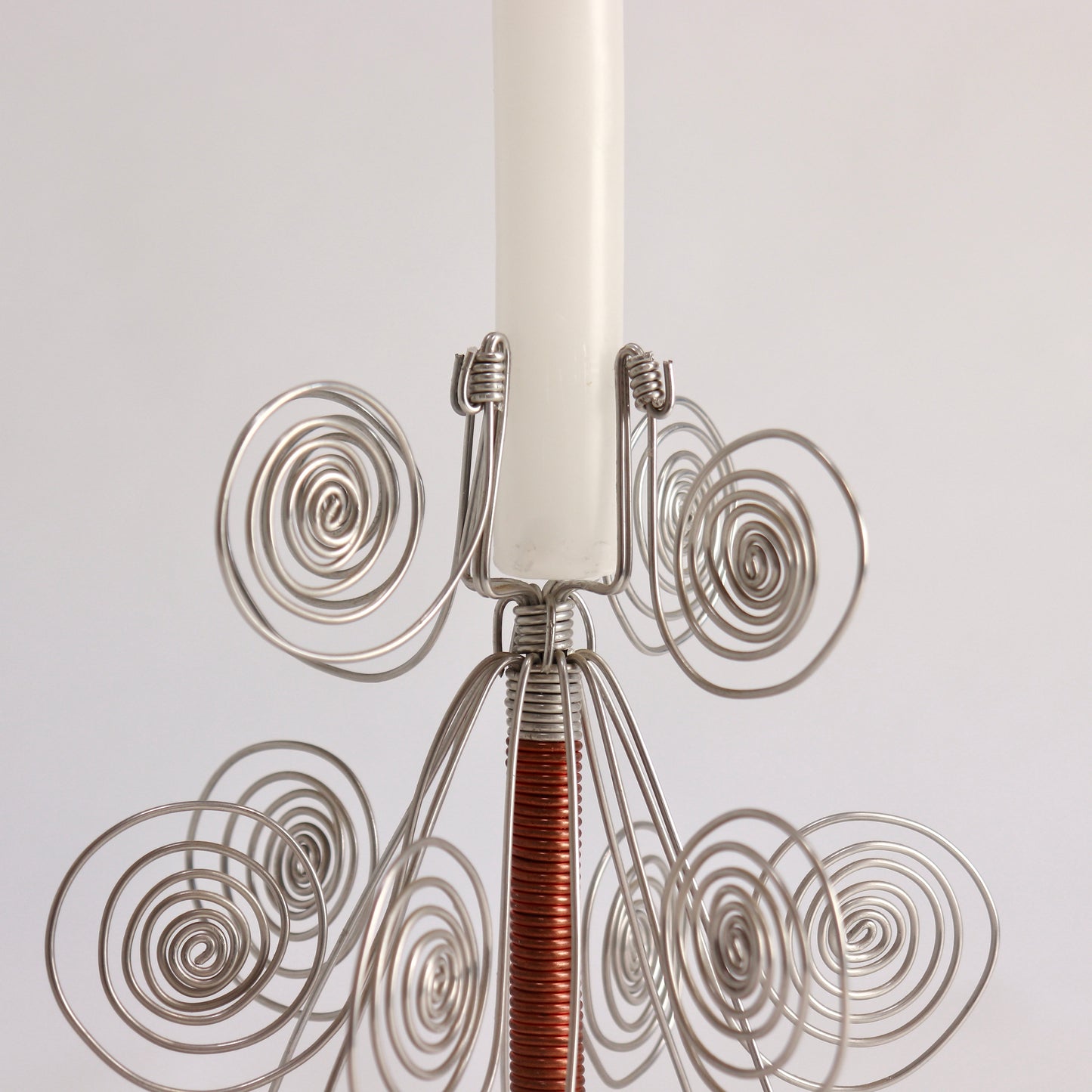 Folk art wire candle holder with decorative spiral forms