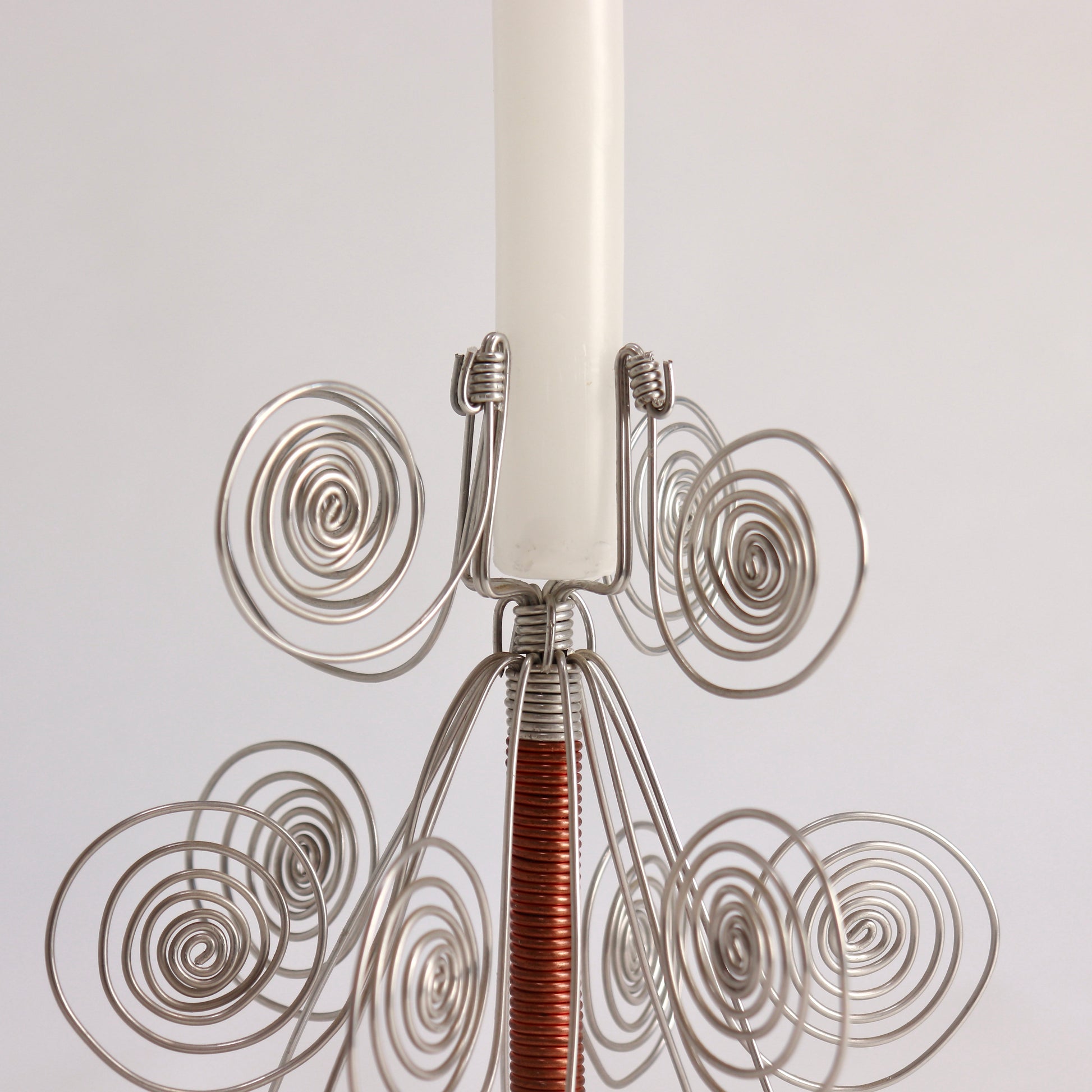 Folk art wire candle holder with decorative spiral forms
