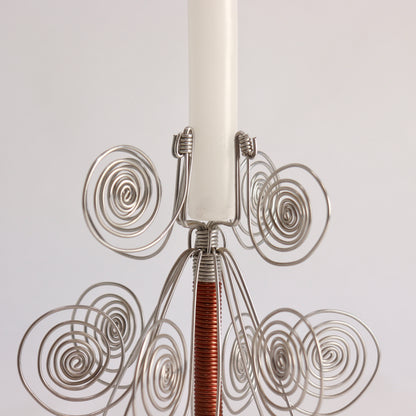 Folk art wire candle holder with decorative spiral forms
