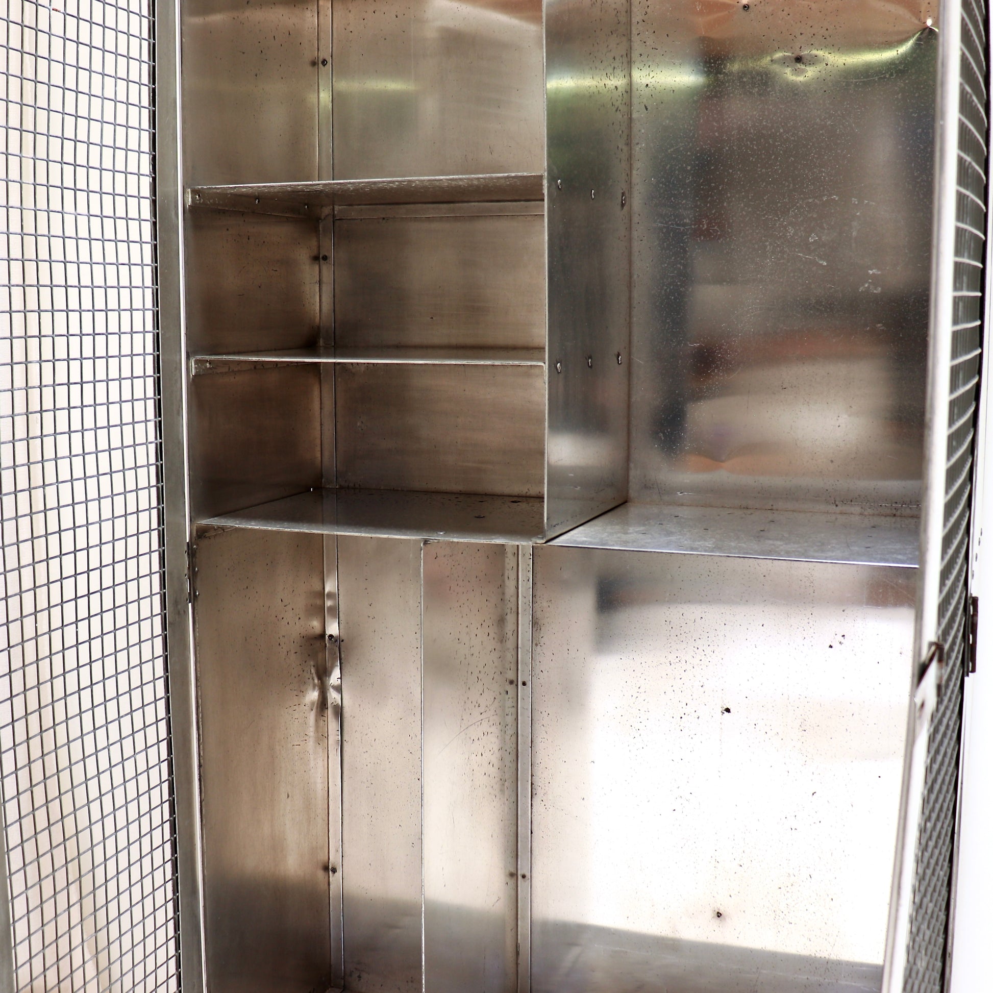 Interior shelving and storage compartments in aluminium cabinet.