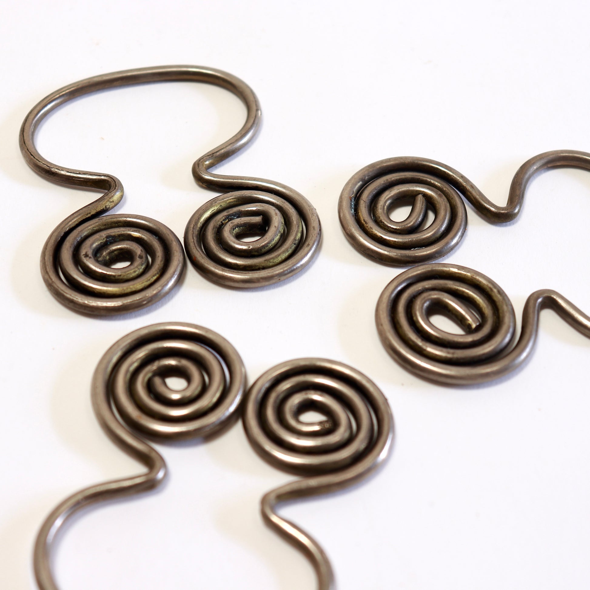 Close-up of sculptural spiral napkin ring detail.