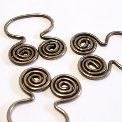 Close-up of sculptural spiral napkin ring detail.