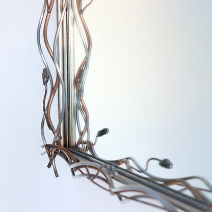 Sculptural metal mirror inspired by organic modernist design