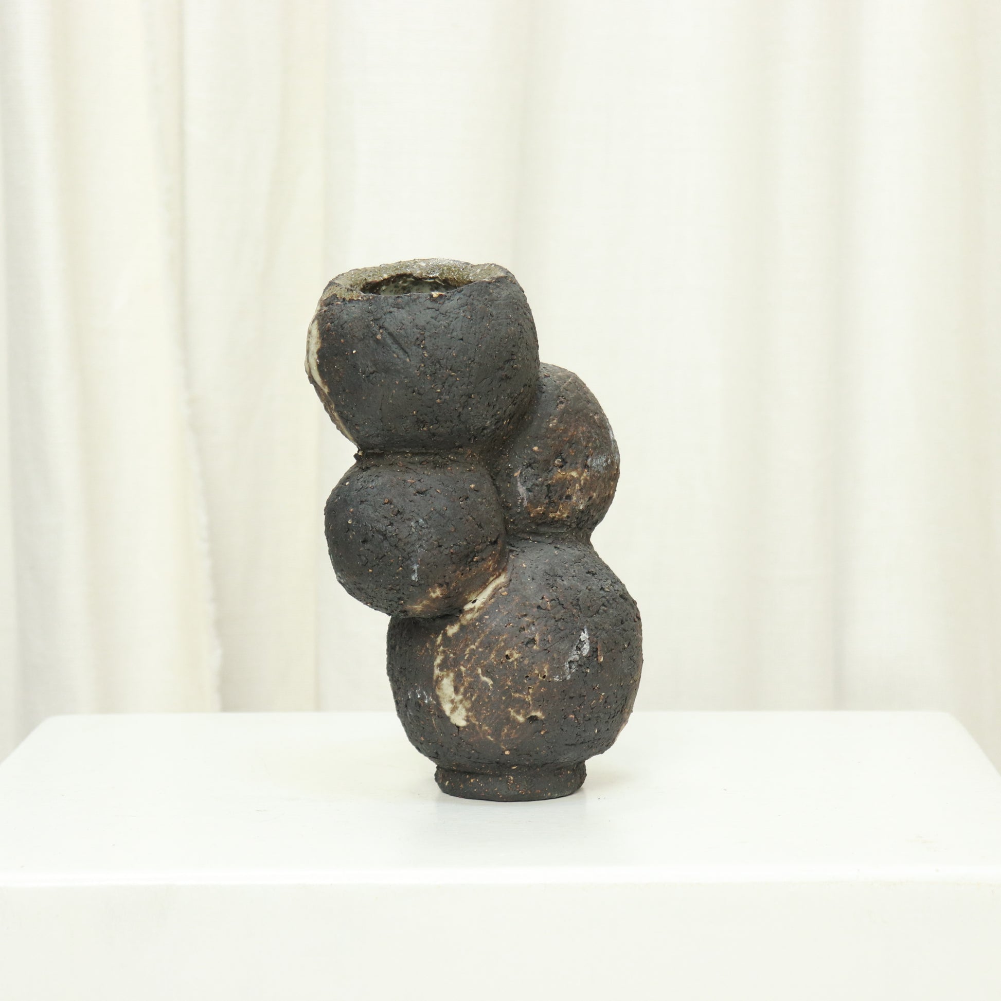 Sculptural hand-built ceramic vase with volcanic clay texture